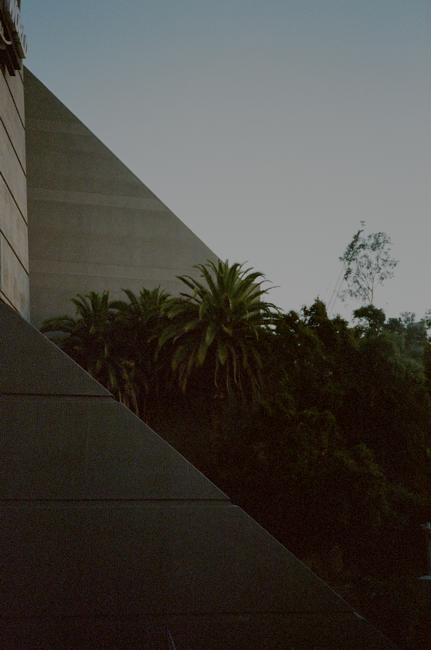 A large, dark staircase leading up to a building, with a clear sky in the background