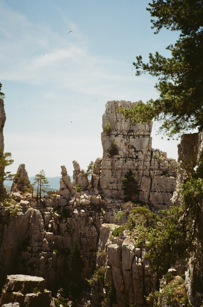 A scenic view of a rocky mountain landscape with a clear blue sky