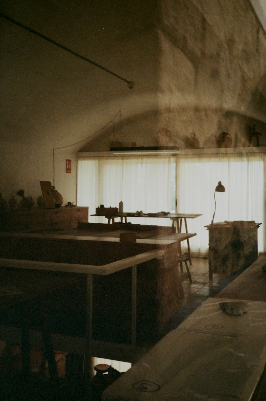 A dimly lit room with a workbench and tools, suggesting a workshop or craft space