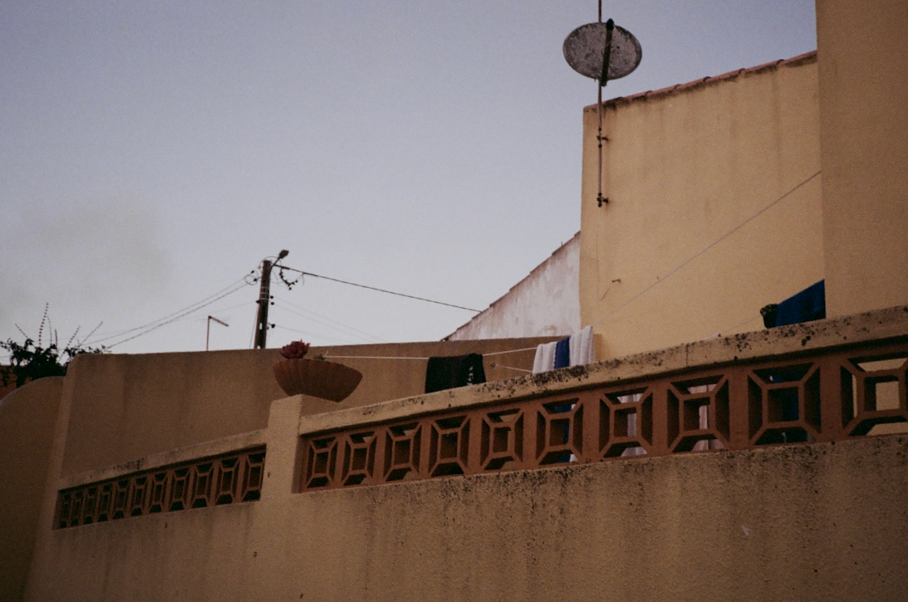 A building with a satellite dish, seen from a low angle