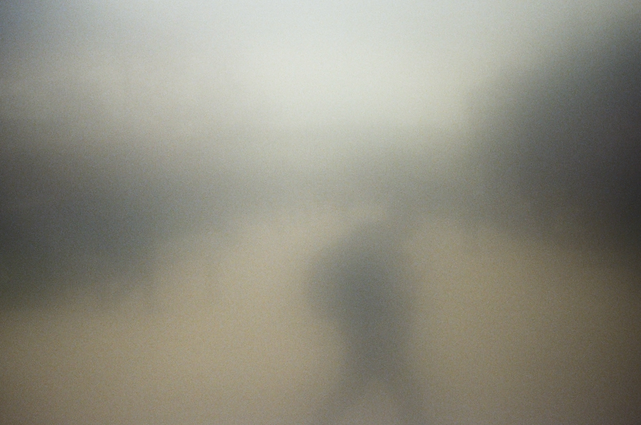 A blurry image of a person walking on a street