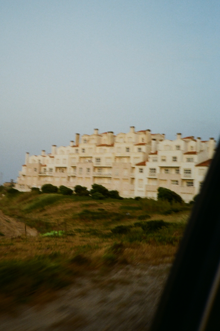 A coastal town with a row of houses on a hillside