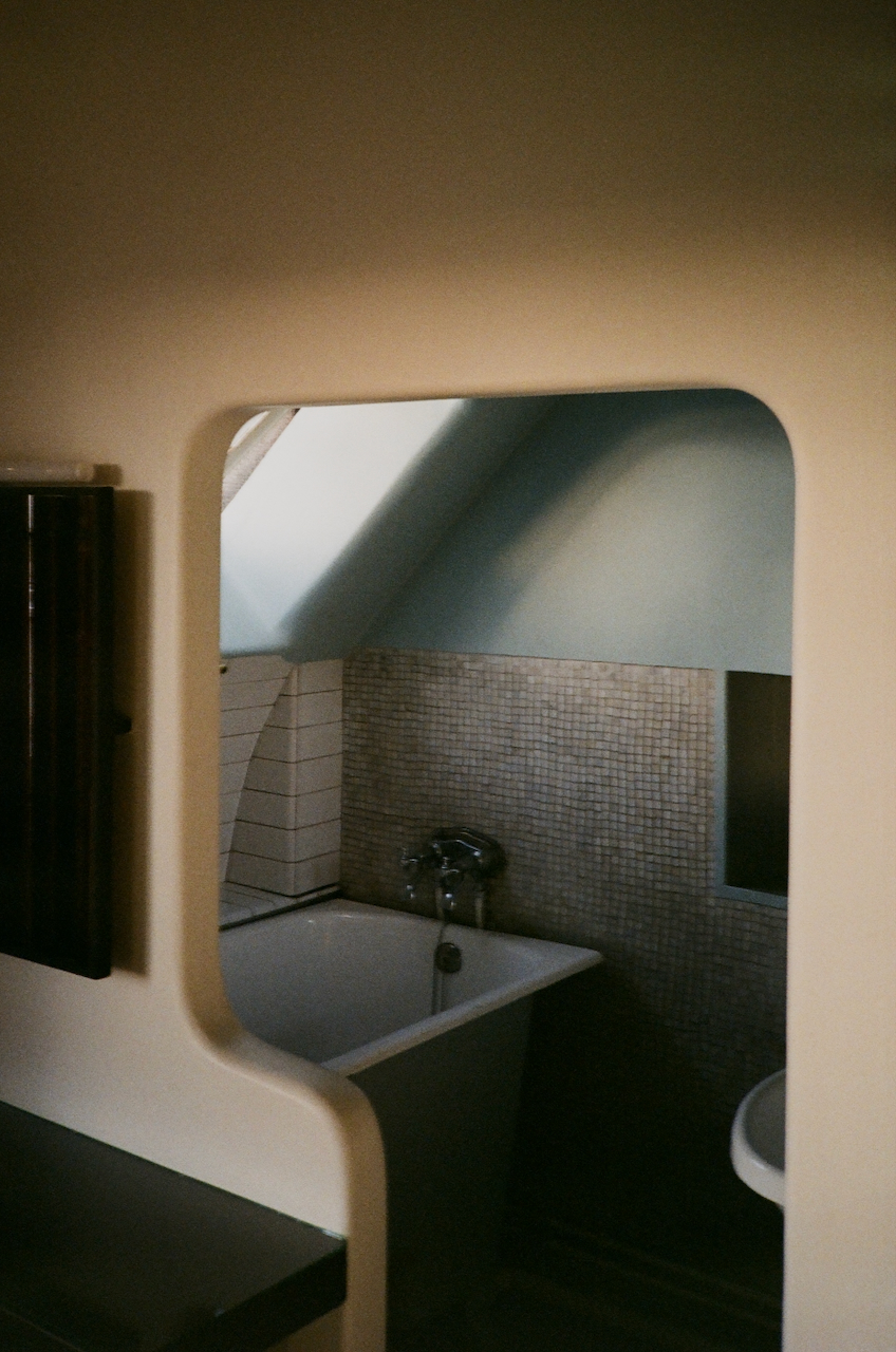 A bathroom with a round sink and a window