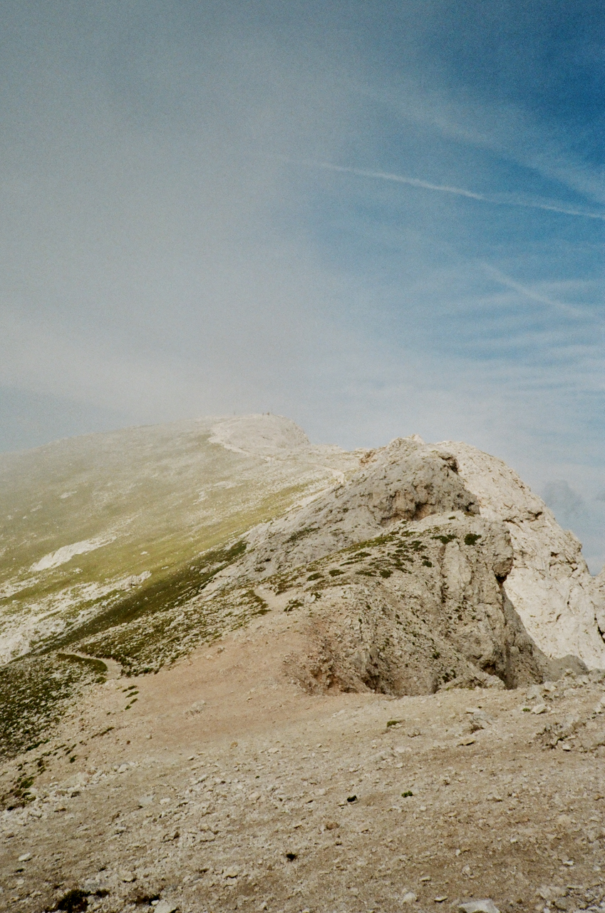 A mountain peak with a clear sky in the background
