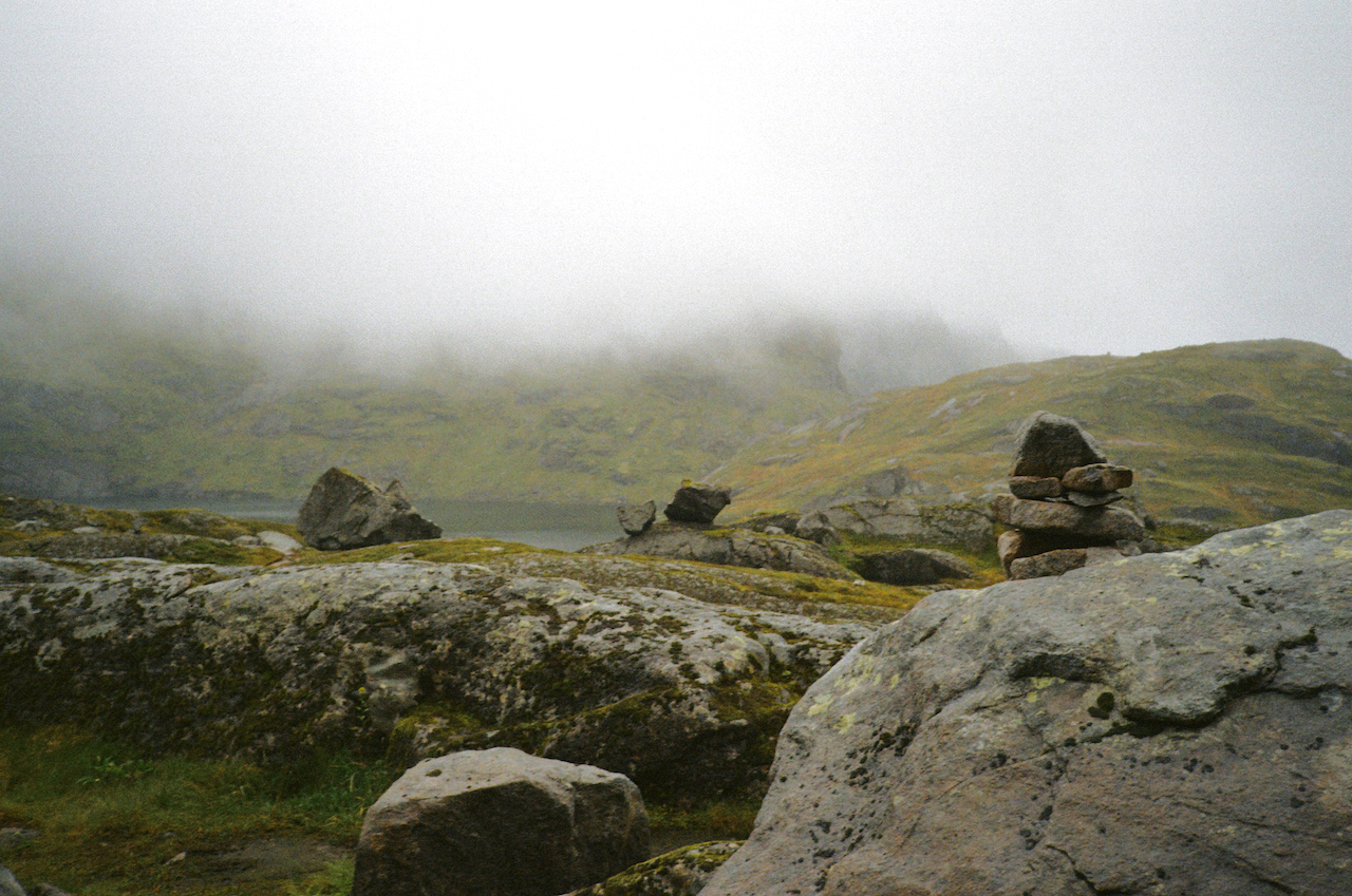 A rocky landscape with fog and a few rocks